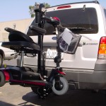 Burbank Electropedic TRILIFT Ultra Lite carrying a Pride gogo on a Ford Explorer.