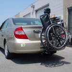 Burbank Electropedic TRILIFT Ultra Lite carrying a manual wheelchair on a Toyota Camry.