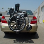Burbank Electropedic TRILIFT Ultra Lite carrying a manual wheelchair on a Toyota Camry.
