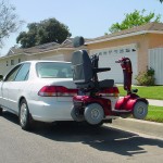 Burbank Electropedic TRILIFT Classic on a class II Receiver Hitch, carrying a shoprider Scooter on a Honda Accord.